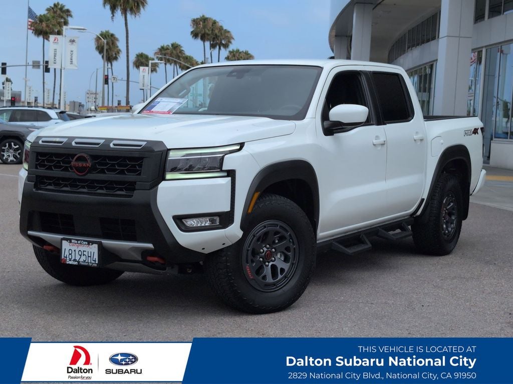 2025 Nissan Frontier PRO-4X in Glacier White — front three-quarter view